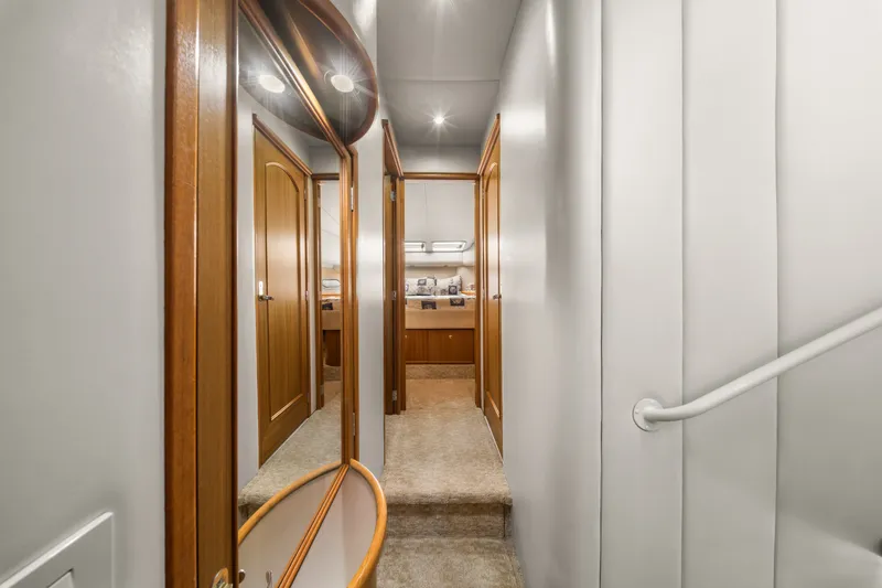 Slide: The Image of Interior hallway of 2001 Bayliner 5788 Pilot House Motoryacht with wooden doors and carpeted floor. - 28