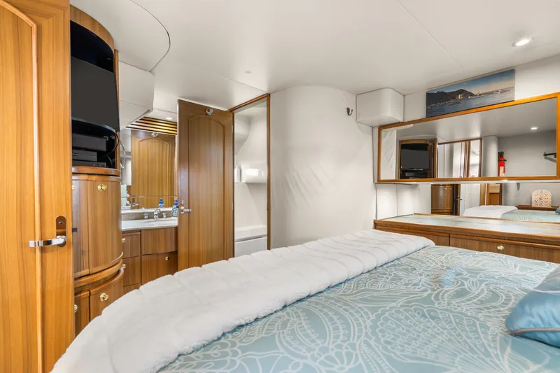 Slide: The Image of Luxurious bedroom interior of 2001 Bayliner 5788 Pilot House Motoryacht with wood accents and modern amenities. - 34