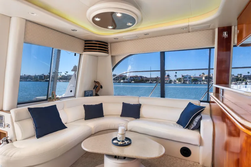 Slide: The Image of Luxurious interior of 2001 Bayliner 5788 Pilot House Motoryacht with waterfront view. - 19