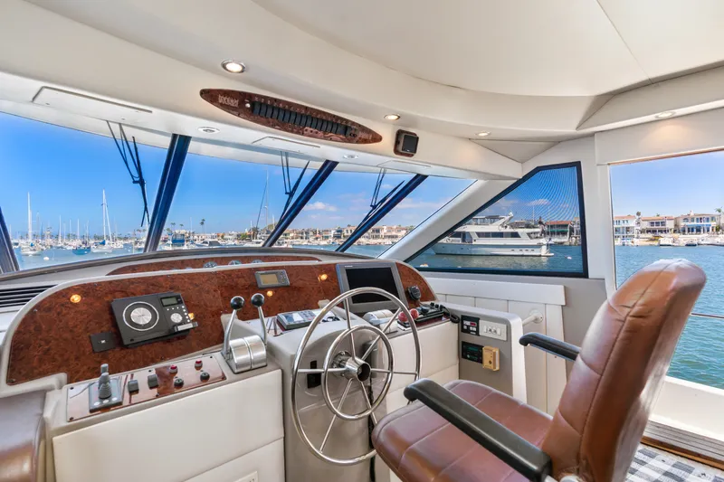 Slide: The Image of 2001 Bayliner 5788 Pilot House Motoryacht helm with marina view. - 26