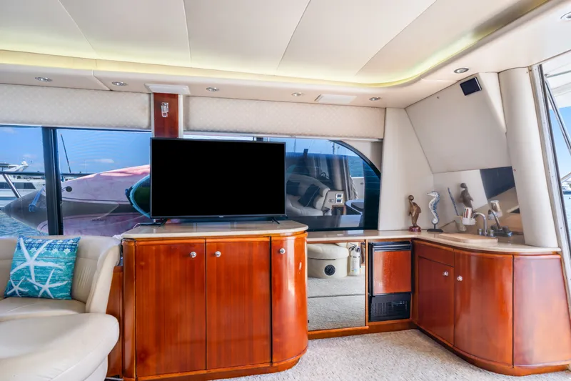 Slide: The Image of Luxurious interior of 2001 Bayliner 5788 Pilot House Motoryacht with TV and elegant cabinetry. - 20