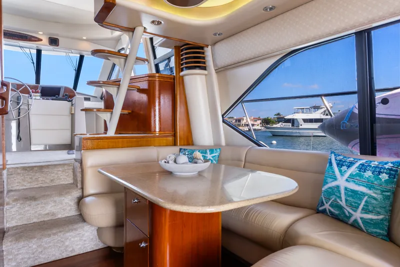 Slide: The Image of Luxurious interior of 2001 Bayliner 5788 Pilot House Motoryacht with elegant seating and waterfront view. - 21