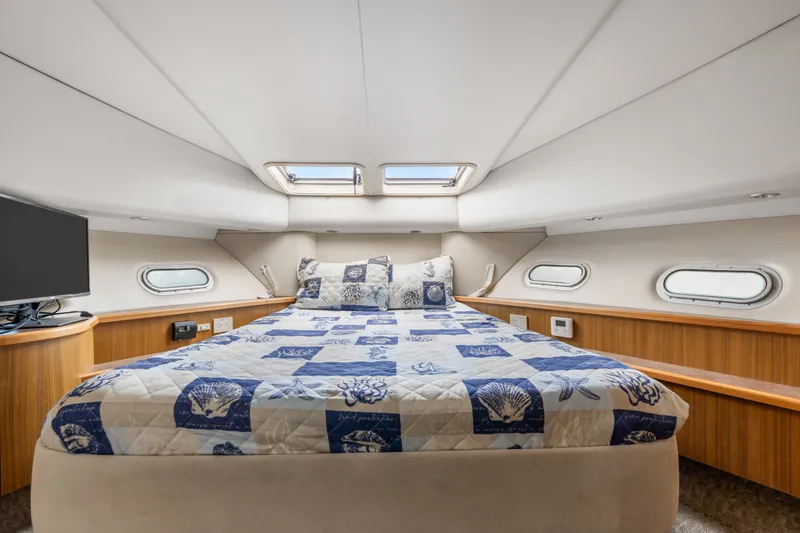 Slide: The Image of Luxurious bedroom in 2001 Bayliner 5788 Pilot House Motoryacht with nautical-themed bedding. - 37