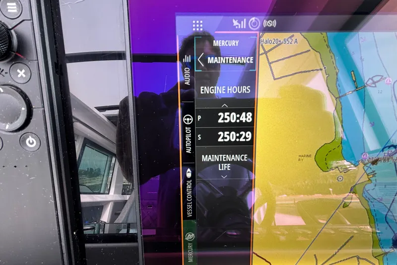 Slide: The Image of Display screen on 2024 Axopar 37 XC Cross Cabin showing engine hours and navigation map. - 27