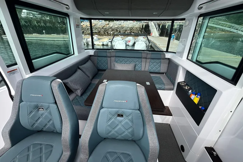 Slide: The Image of Luxurious interior of 2024 Axopar 37 XC Cross Cabin with plush seating and panoramic windows. - 22