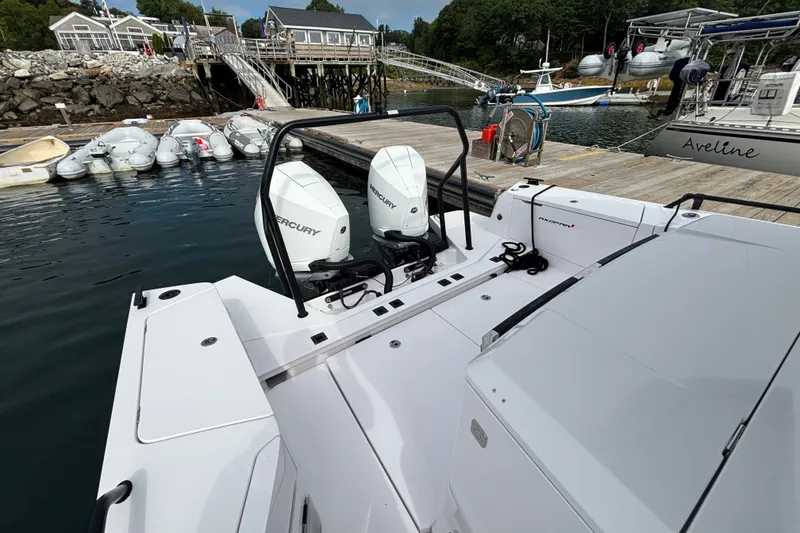 Slide: The Image of 2024 Axopar 37 XC Cross Cabin with dual Mercury engines docked at a marina. - 9