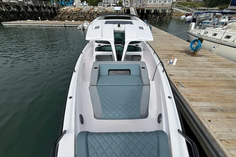 Slide: The Image of 2024 Axopar 37 XC Cross Cabin docked, showcasing sleek design and spacious seating. - 32