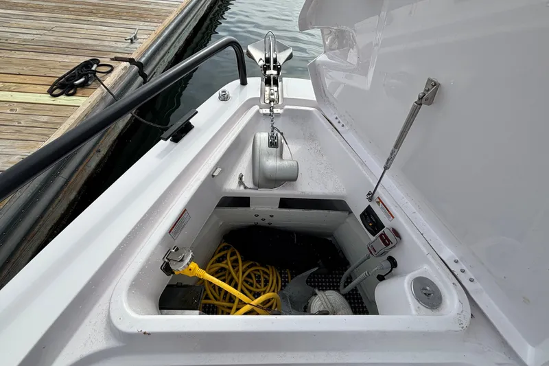 Slide: The Image of Anchor compartment of 2024 Axopar 37 XC Cross Cabin with yellow rope and equipment. - 33