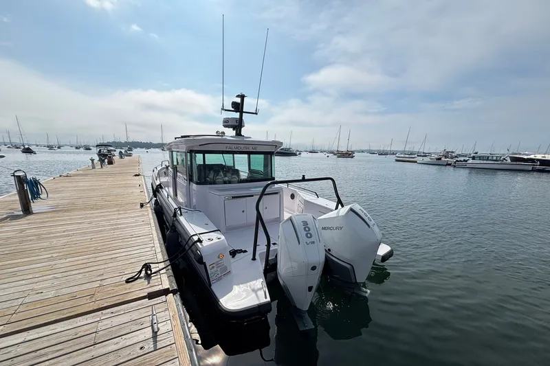 Slide: The Image of 2024 Axopar 37 XC Cross Cabin docked with twin Mercury engines. - 7
