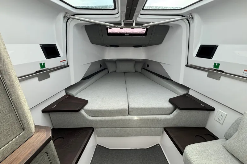 Slide: The Image of 2024 Axopar 37 XC Cross Cabin interior with modern gray bedding and sleek design. - 29