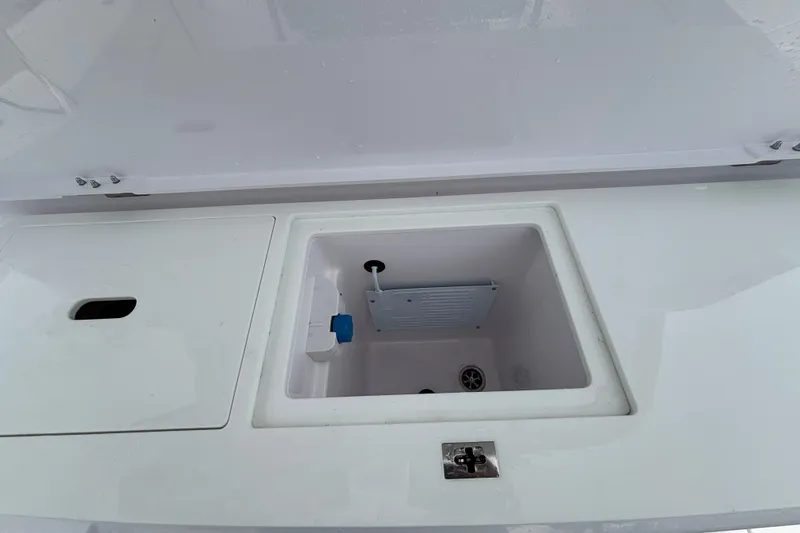 Slide: The Image of 2024 Axopar 37 XC Cross Cabin boat storage compartment with open lid. - 14
