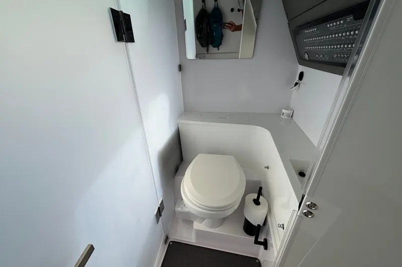 Slide: The Image of 2024 Axopar 37 XC Cross Cabin bathroom with modern fixtures and compact design. - 28