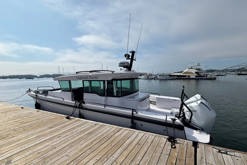 Slide: The Image of 2024 Axopar 37 XC Cross Cabin docked at a marina, showcasing sleek design and modern features. - 4