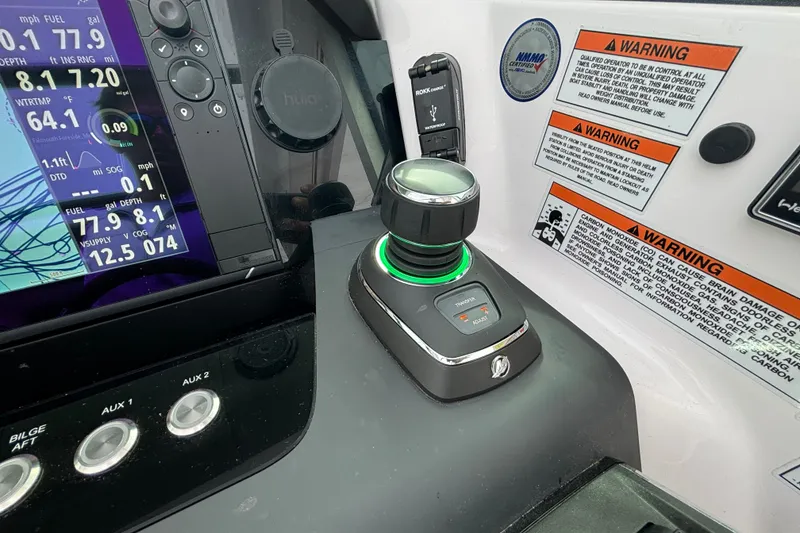 Slide: The Image of Control panel of 2024 Axopar 37 XC Cross Cabin with joystick and warning labels. - 26