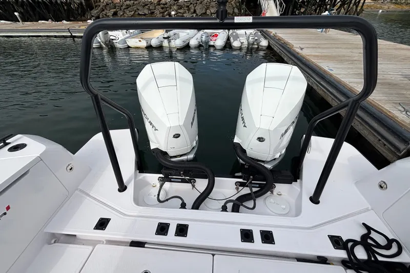 Slide: The Image of 2024 Axopar 37 XC Cross Cabin with twin Mercury outboard engines at dock. - 10