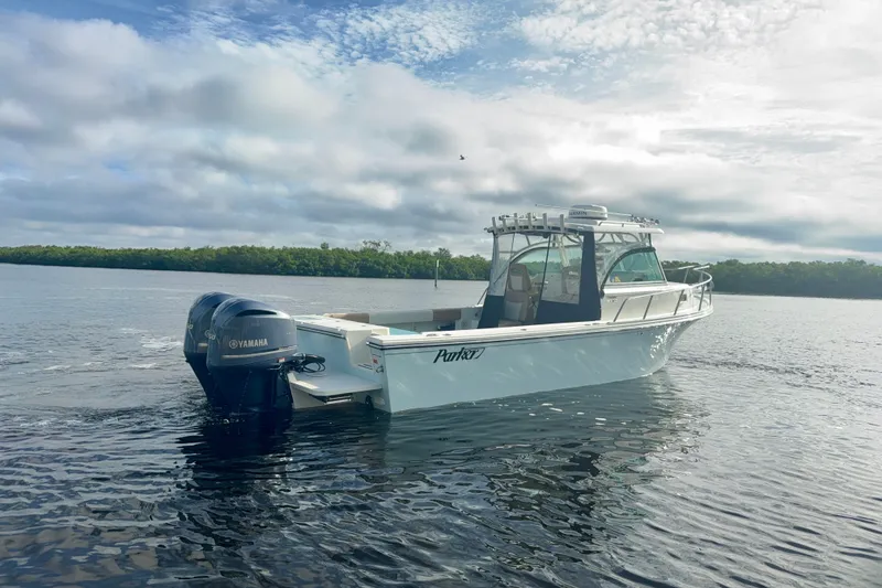 Slide: The Image of 2017 Parker 2810 XLD Walkaround boat on calm water with Yamaha engine. - 17
