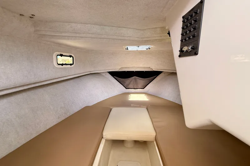 Slide: The Image of Interior cabin of 2017 Parker 2810 XLD Walkaround boat, featuring beige seating and control panel. - 27