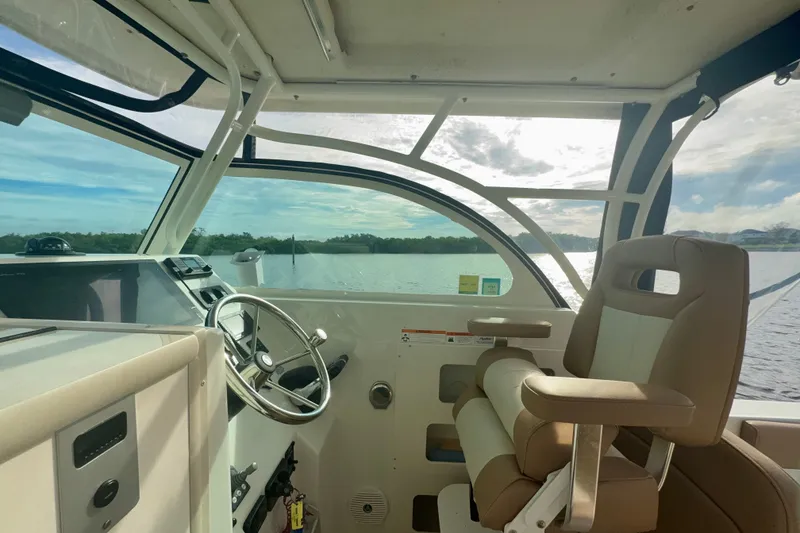 Slide: The Image of Interior view of 2017 Parker 2810 XLD Walkaround boat with steering wheel and captain's chair. - 4