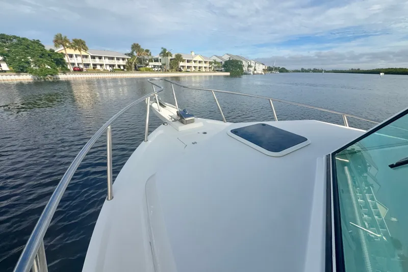 Slide: The Image of 2017 Parker 2810 XLD Walkaround boat on calm water near waterfront homes. - 26
