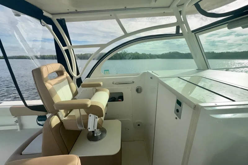 Slide: The Image of Interior view of 2017 Parker 2810 XLD Walkaround boat with helm seat and water view. - 8