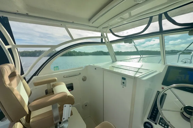 Slide: The Image of Interior view of 2017 Parker 2810 XLD Walkaround boat cockpit with steering wheel and seating. - 7