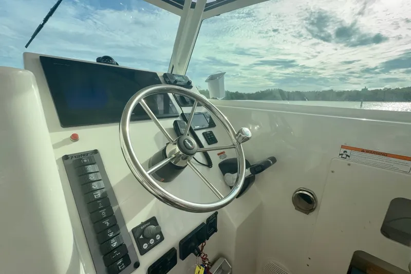 Slide: The Image of 2017 Parker 2810 XLD Walkaround boat helm with steering wheel and control panel. - 6