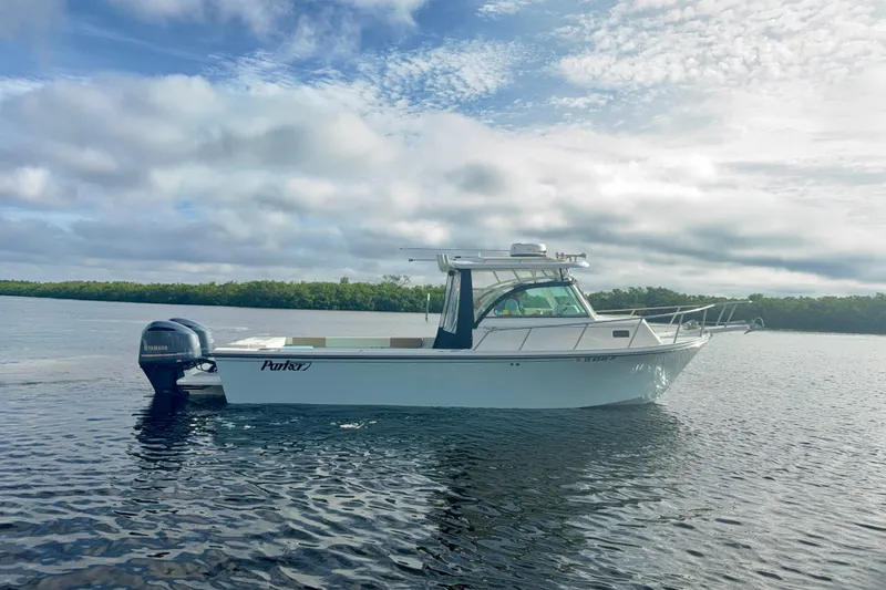 The Image of 2017 Parker 2810 XLD Walkaround boat on calm water under cloudy sky. - 0