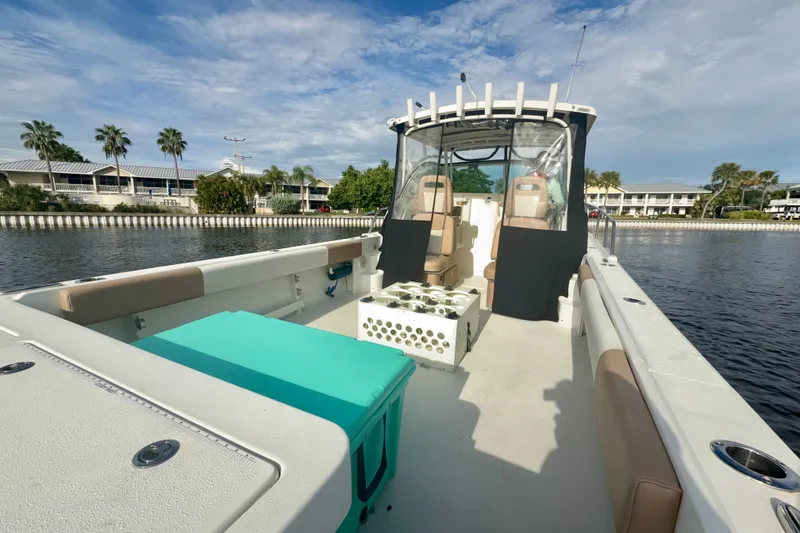 Slide: The Image of 2017 Parker 2810 XLD Walkaround boat on calm water, featuring spacious deck and seating. - 14