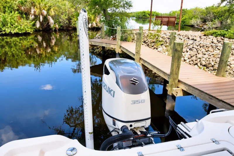 Slide: The Image of 2021 Blue Wave 2800 Makaira boat with Suzuki 350 engine docked by a wooden pier. - 17