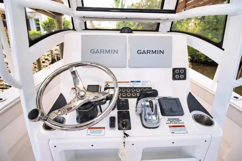 Slide: The Image of 2021 Blue Wave 2800 Makaira boat helm with Garmin displays and controls. - 32
