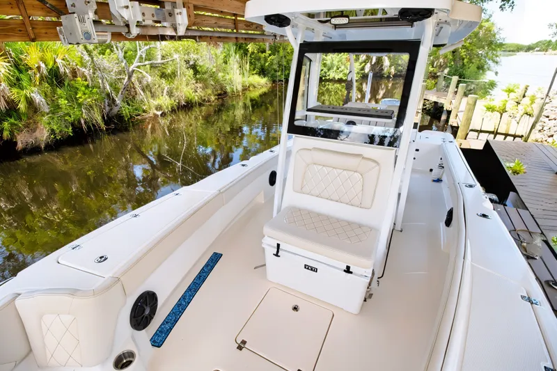 Slide: The Image of 2021 Blue Wave 2800 Makaira boat docked by a lush, scenic waterway. - 48