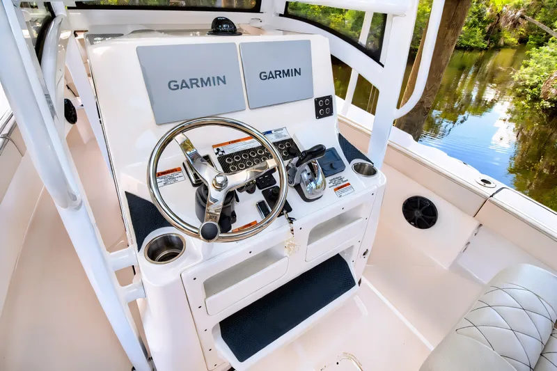 Slide: The Image of 2021 Blue Wave 2800 Makaira boat console with Garmin displays and steering wheel. - 30