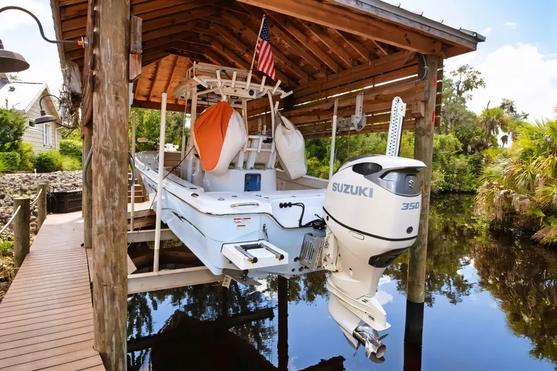 Slide: The Image of 2021 Blue Wave 2800 Makaira boat with Suzuki 350 engine in covered dock. - 7