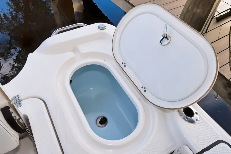 Slide: The Image of Open hatch on 2021 Blue Wave 2800 Makaira boat, revealing storage compartment. - 21