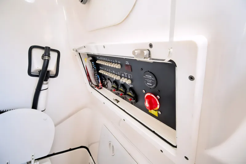 Slide: The Image of Electrical panel inside 2021 Blue Wave 2800 Makaira boat, featuring switches and controls. - 58