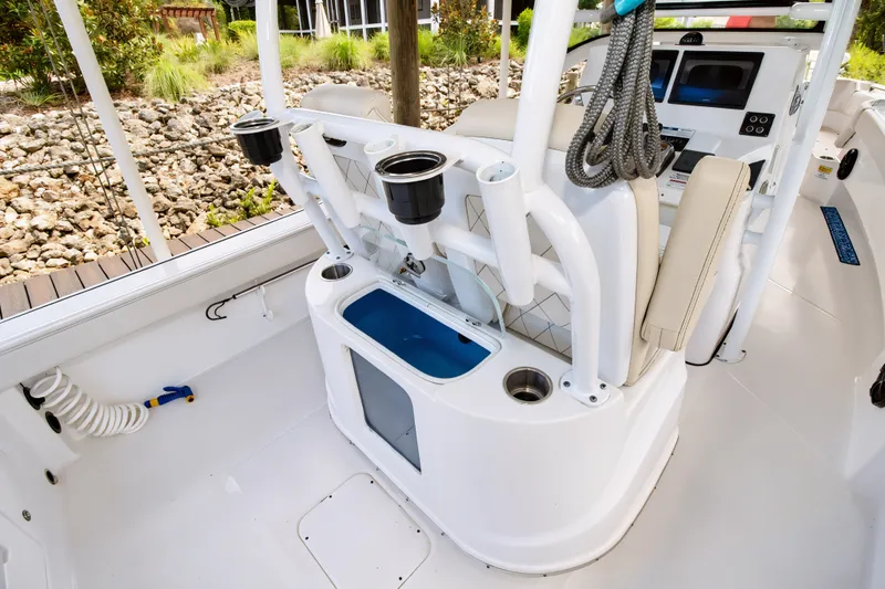 Slide: The Image of 2021 Blue Wave 2800 Makaira boat interior with fishing rod holders and seating. - 33