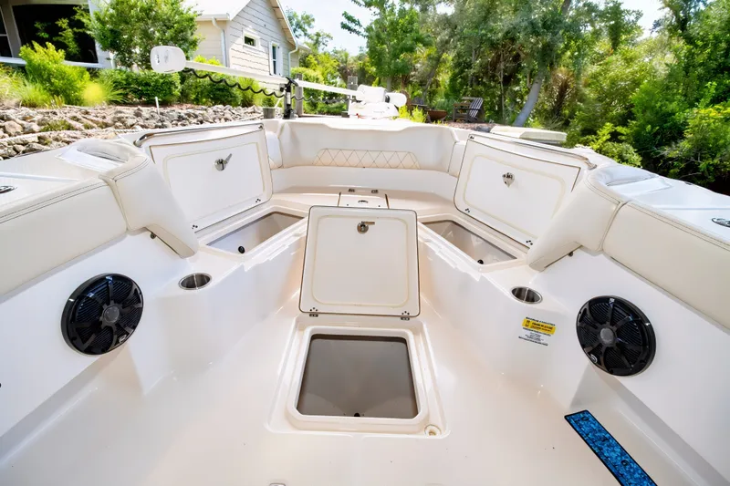 Slide: The Image of 2021 Blue Wave 2800 Makaira boat interior with open storage compartments and speakers. - 43