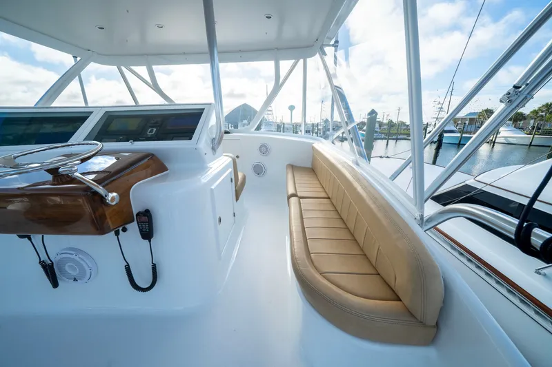 Slide: The Image of The image shows the cockpit of a 2002 Custom Carolina Ritchie Howell boat with a leather bench. - 21