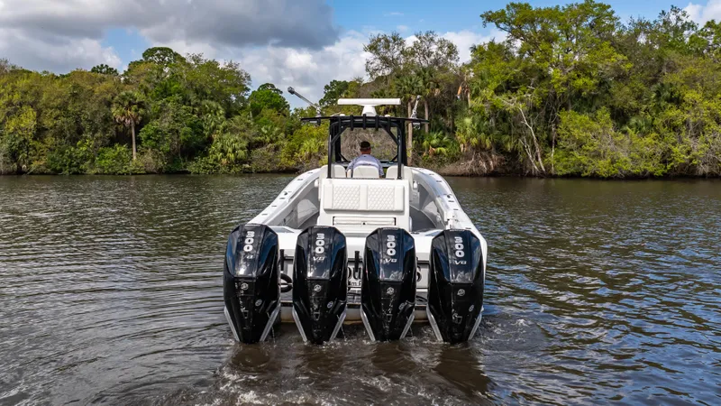 Slide: The Image of 2023 Front Runner 39 Center Console boat with four powerful engines on a scenic river. - 16
