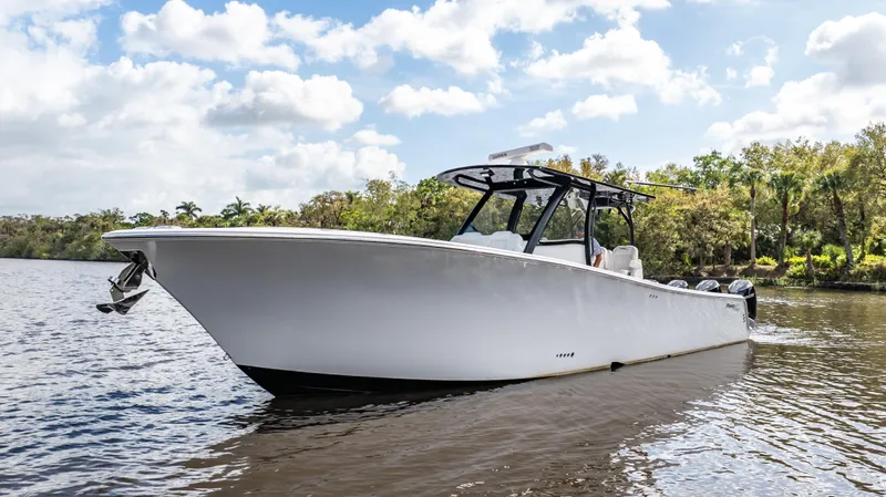 Slide: The Image of 2023 Front Runner 39 Center Console boat on a calm river under a cloudy sky. - 12