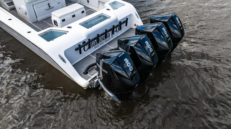 Slide: The Image of 2023 Front Runner 39 Center Console boat with four powerful outboard engines in water. - 10