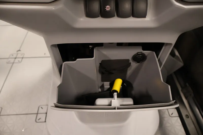 Slide: The Image of Storage compartment of 2023 Sea-Doo Switch 16 with accessories and controls. - 19