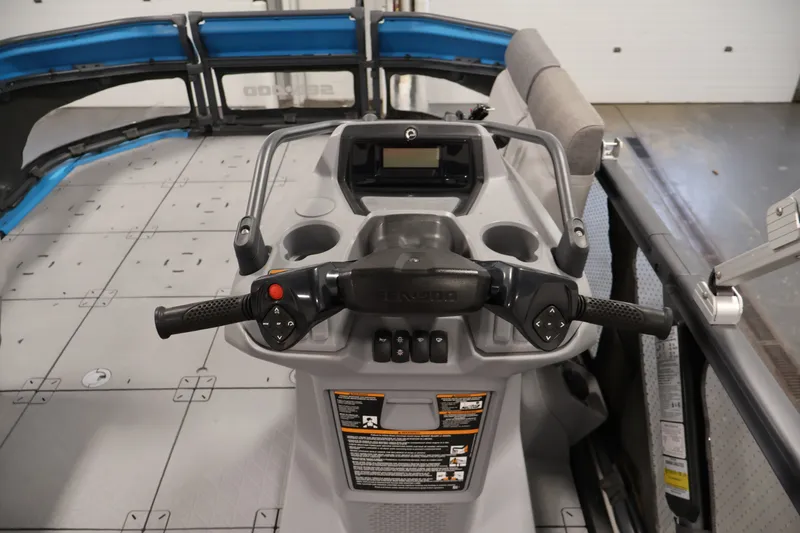 Slide: The Image of 2023 Sea-Doo Switch 16 dashboard with steering controls and cup holders. - 14