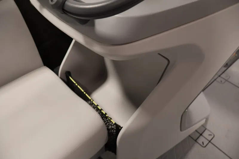 Slide: The Image of 2023 Sea-Doo Switch 16 interior detail with steering wheel and storage compartment. - 13