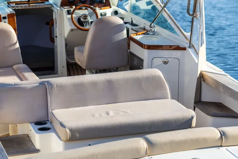 Slide: The Image of 2018 Hunt Yachts Harrier 26 interior with plush seating and elegant design on the water. - 19