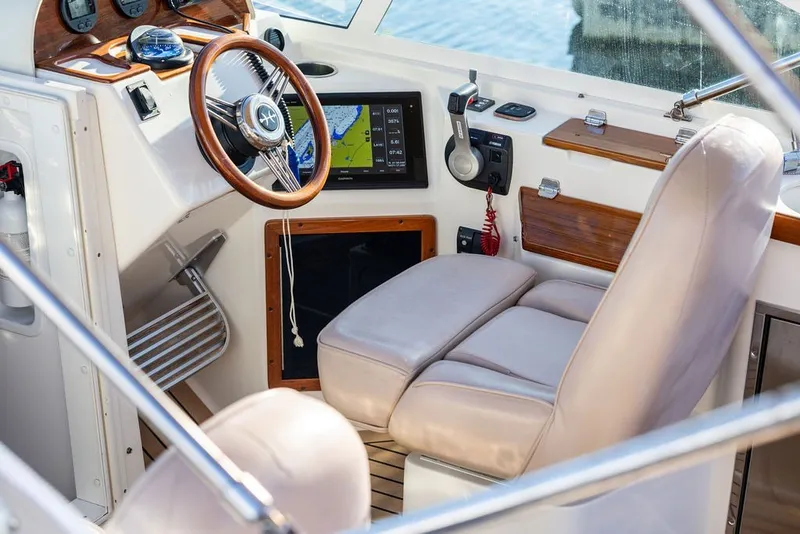 Slide: The Image of 2018 Hunt Yachts Harrier 26 cockpit with steering wheel and navigation display. - 13
