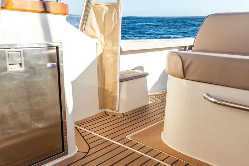 Slide: The Image of 2018 Hunt Yachts Harrier 26 interior with teak flooring and ocean view. - 15