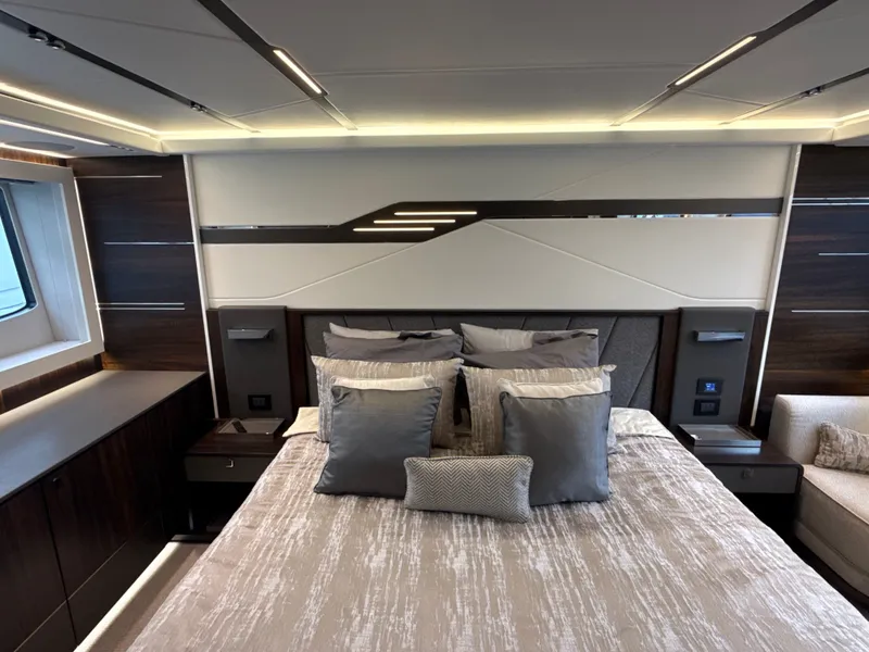 Slide: The Image of Luxurious bedroom with modern design, large windows, and sleek lighting on a Sunseeker Predator 65. - 53