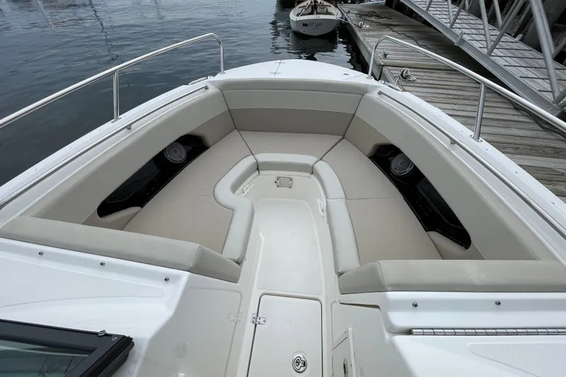 Slide: The Image of 2023 Boston Whaler 240 Vantage boat interior with cushioned seating at dock. - 61