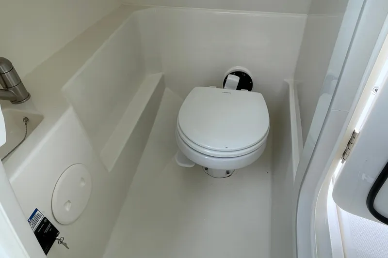Slide: The Image of 2023 Boston Whaler 240 Vantage boat bathroom with compact toilet and sink. - 50